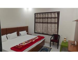 A bed or beds in a room at Ma Parvati residency, Chitrakoot