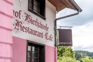 a pink building with writing on the side of it at pop-up stuub feldberg in Feldberg