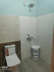 a bathroom with a toilet and a faucet at Maa durga home stay in Faizābād
