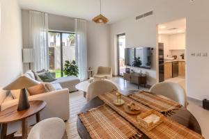 a living room with a couch and a table at Your Cozy Yas Island Escape in Abu Dhabi