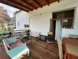 a patio with chairs and a table and a tableablish at Vladi's Home in Çorovodë