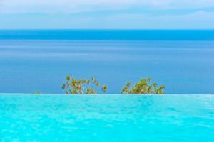 a view of the ocean from a swimming pool at L Oasis Moderne piscine vue mer in Roquebrune-Cap-Martin