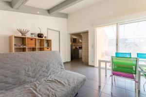 a living room with a bed and a table and chairs at Villa les Mimosas in Bormes-les-Mimosas