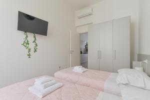 Un pat sau paturi într-o cameră la Le Case sul Parco 2