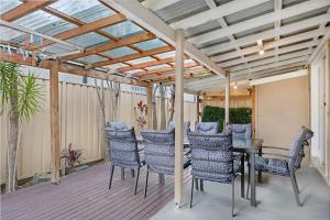 a patio with a table and chairs under a pergola at Sans Souci 4-Bedroom Home Near Beach in Sydney
