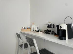 a white counter with a coffee maker on it at Piccola Corte in Udine +27 photos