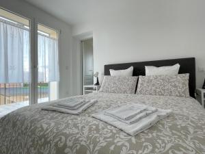 a bedroom with a bed with two towels on it at Piccola Corte in Udine