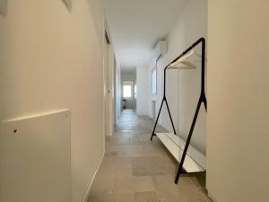 a hallway with a mirror on a wall at Piccola Corte in Udine