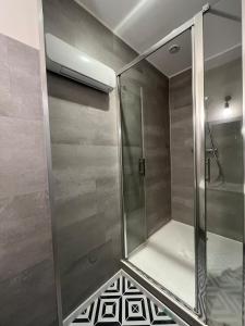 a shower with a glass door in a bathroom at Cozy Appartment Champollion 1 in Figeac +16 photos
