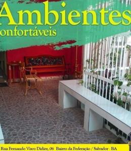 a sign for a store with a table and a bench at República e hostel da federação vagas compartilhada carnaval carnaval in Salvador