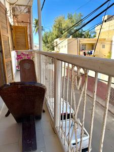 a balcony with a chair on a porch at Magnifique studio centre ville Saint louis in Saint-Louis