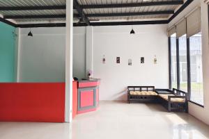 a room with a red counter and benches in it at YUTAKA INN Bypass Mojokerto in Mojokerto