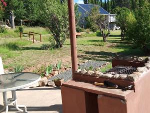 a outdoor grill with a table in a park at Gentle Presence Cottage 2 - Garden Unit in Clarens