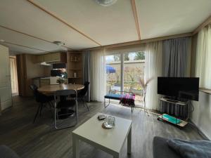 a living room with a couch and a table at Veluwe Flirt in Epe