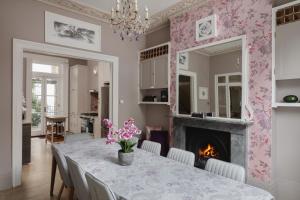 a dining room with a table and a fireplace at Central London House Zone 1 in London
