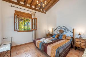 a bedroom with a bed and a window at Casa Rocío Castril in Castril