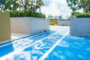 a blue basketball court with a basketball hoop on it at Laguna Beachside residences apartamens, walking distance to the sea in Bang Tao Beach