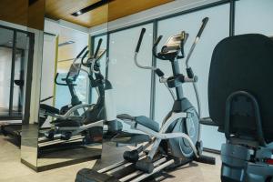 a row of exercise bikes in a gym at Laguna Beachside residences apartamens, walking distance to the sea in Bang Tao Beach +29 photos