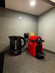 a coffee maker and a toaster sitting on a counter at Luxury Studio 111 - Orange in Aarau