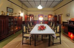 a dining room with a table with flowers on it at Panthiya Estate Bungalow in Matugama