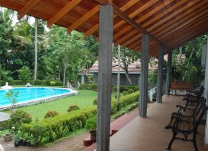 a patio with a swimming pool and a house at Panthiya Estate Bungalow in Matugama