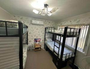 a bedroom with two bunk beds and a chandelier at Bluetongue Hideout in Mount Pritchard