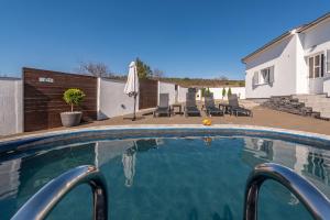 a swimming pool in front of a house at Villa Sea Pearl ZadarVillas in Maslenica