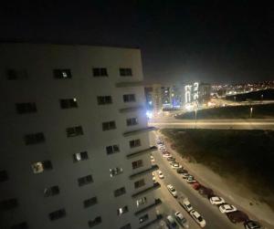 a view of a building at night with a parking lot at ASDK Home 908-14 in Dubai