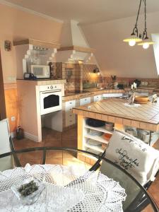 a kitchen with a glass table and a counter top at Apartmaji ARKO in Ribnica +31 photos