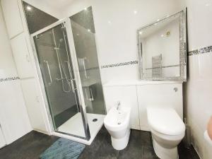 a bathroom with a shower and a toilet and a sink at Comfortable Cottage in Greater Manchester in Glazebury +8 photos