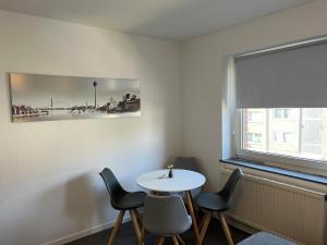 a room with a table and chairs and a window at Wohnung mit Balkon am Rhein in Düsseldorf