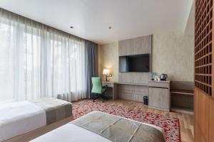 Letto o letti in una camera di Hotel Ashwatth