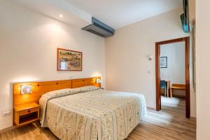 Postel nebo postele na pokoji v ubytování Hotel Barsotti