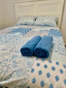 a bed with two blue towels sitting on it at Cozy Homez Ballarat - Home stay in Alfredton