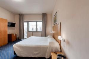 Postel nebo postele na pokoji v ubytování Hotel Barsotti