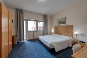 Postel nebo postele na pokoji v ubytování Hotel Barsotti