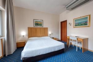 Postel nebo postele na pokoji v ubytování Hotel Barsotti