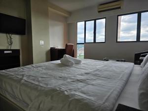 A bed or beds in a room at Kota Kinabalu City Ensuite at SCSP Ming Garden