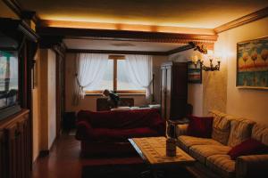 a living room with a couch and a table at Casa Aurine di Zaccaria in Frassenè