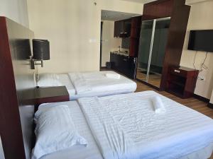 A bed or beds in a room at Kota Kinabalu City Ensuite at SCSP Ming Garden