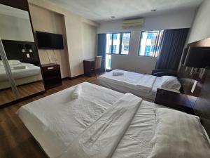 A bed or beds in a room at Kota Kinabalu City Ensuite at SCSP Ming Garden