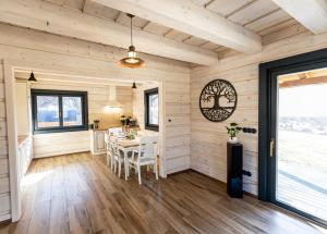 a dining room with wooden walls and a table at Ozónia Wellness House in Šahy