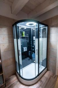 a large glass enclosure in a room with wooden floors at Ozónia Wellness House in Šahy +41 photos