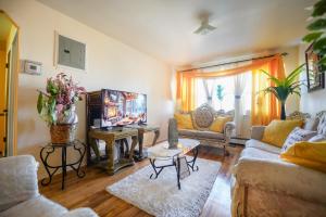 a living room with two couches and a table at Chekells Cozy stay close to everything Free WIFI in Brooklyn