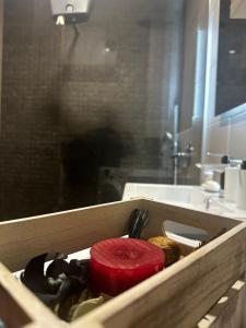 a wooden drawer with a red item in a bathroom at Hill Apartment in Podgorica +40 photos