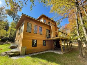 a large wooden house in the woods at Luxury Modern Cabin near Skiing in Plymouth