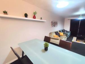 a living room with a table and a couch at Comfort Palace in Newcastle upon Tyne
