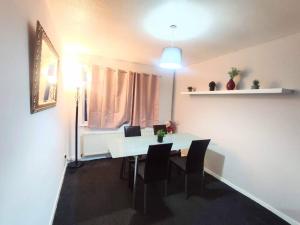 a dining room with a white table and chairs at Comfort Palace in Newcastle upon Tyne