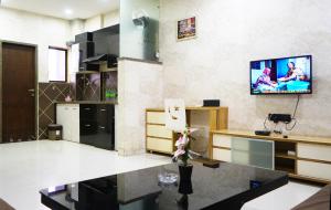 a living room with a tv on the wall at STAY10 Apartment Hotel in Indore