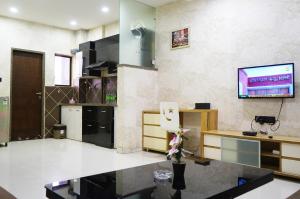 a large living room with a tv on the wall at STAY10 Apartment Hotel in Indore